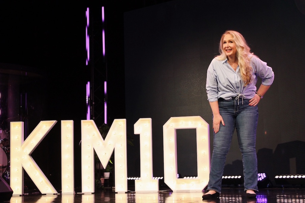 Woman speaking on a KIM10 stage.